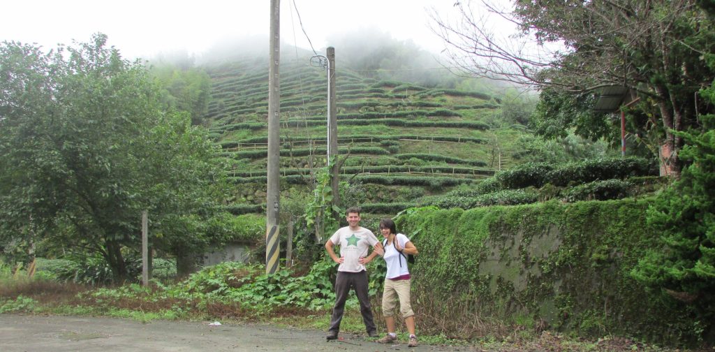 Joel and Emily in front of a tired mountain tea field