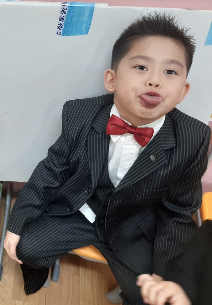 Little boy sticking out his tongue