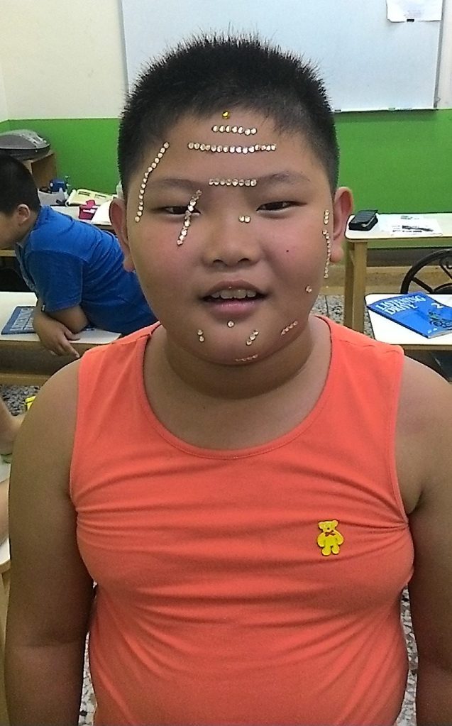 Perry with face covered in rhinestones